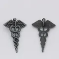 Detailed macro view showing the front and back of the vintage silver caduceus charm - 30x20 / Antique Pewter