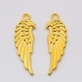 Pair of vintage gold alloy wing charms with detailed feather texture and hanging loops - Gold