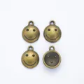 Set of four vintage bronze smiley face alloy pendants with hanging loops for DIY jewelry - Antique Bronze