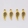 Close-up of four antique gold alloy wing charms with detailed feather texture for DIY jewelry - Antique Gold