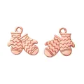 Macro detail of rose gold Christmas glove charms with bow relief and textured metal finish - Rose Gold