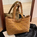 Quilted caramel tote bag with white bow embroidery in a stylish down jacket style - Yellow