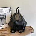 Versatile black faux leather backpack with geometric diamond design and silver zippers - Black