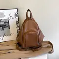 Brown PU leather backpack with silver zipper and large capacity in a minimalist design - Brown