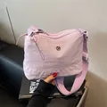 Light purple nylon crossbody bag with wide shoulder strap and dual zipper compartments - Purple