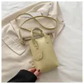 Vertical yellow mini crossbody bag with cute dog charm and top handle on casual fabric - Yellow