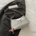 Silver bow shoulder bag with crocodile texture and metal knot detail in a modern style - Silver