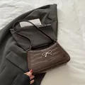 Dark brown crocodile pattern underarm bag with a vintage silver bow metal clasp - Brown