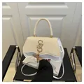 Beige woven straw and white leather crossbody bag with golden hardware and tassel charm - White