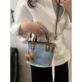 Blue denim and brown leather bucket bag with dog charm and gold lettering details - Blue
