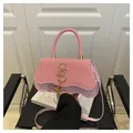 Pink lady crossbody bag with wave flap, straw texture, and gold S hardware - Pink