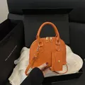 Bright orange shell handbag with matching mini pouch and adjustable strap on silk - Orange