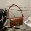 Minimalist caramel brown leather shoulder bag with sleek silver U-shaped metal buckle - Brown