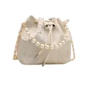 Elegant white bucket bag with floral bamboo print, pearl handle and chain strap - Off-White