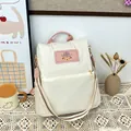 Schicker Oxford-Stoff Rucksack in Beige mit rosa Akzenten und buntem Schultergurt - Weiß