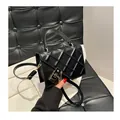 Black quilted crossbody bag with gold hardware and elegant chain detail for women - Black