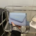 Light blue square crossbody bag with textured fabric and stylish wide jacquard shoulder strap - Blue