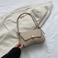 Minimalist beige denim underarm bag with rectangular metal lock and knotted cord strap - Khaki