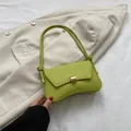 Neon green leather crescent shoulder bag with gold metal clasp and knotted strap detail - Green