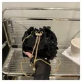 Sparkly black sequin bucket bag with gold chain strap and pearl drawstring detail - Black