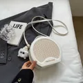 White semi-circular crossbody bag with woven texture and plush ball charm accessory - With Charm / Off White