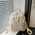 Casual cream-white backpack with pink floral prints featuring multi-pocket design - White