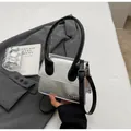 Minimalist silver mirror crossbody bag with black handle and JINGPIN branding - Silver