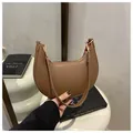 Detail of brown hobo crescent bag with pebble grain leather and golden hardware - Dark Brown