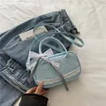 Light blue bowling style crossbody bag with heart lace trim and bow ribbon accent - Blue