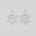 Detailed macro view of two silver-colored vintage ship wheel charms for DIY jewelry - Bright Silver