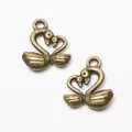 Detailed macro view of vintage bronze swan charms with heart-shaped necks for DIY jewelry - Antique Bronze