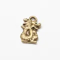 Macro shot of antique bronze dragon pendant with detailed texture for DIY jewelry making - Antique Bronze