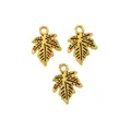 Detailed macro of three gold-plated maple leaf charms for DIY jewelry making and crafts - Antique Gold