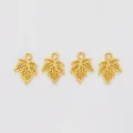 Detailed view of four golden maple leaf charms with intricate veins for DIY jewelry - Gold