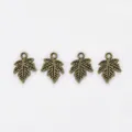 Macro view of four antique bronze maple leaf alloy charms with detailed vein texture - Antique Bronze