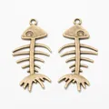 Vintage bronze alloy fish bone pendants for DIY jewelry making on white background - Antique Bronze