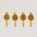 Close-up of four golden lollipop alloy pendants for DIY jewelry making accessories - Antique Gold