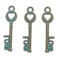 Close-up of three vintage bronze alloy key pendants with heart tops and Love lettering - Antique Green