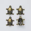 Juego de cuatro colgantes de calavera en aleación de zinc con acabado en bronce antiguo - Bronce Antiguo