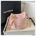 Pink drawstring bucket bag featuring a gold ball charm and woven metal chain strap - No Pendant / Pink