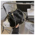 Elegant black velvet drawstring bucket bag with gold chain strap and pompom charm - With Plush Charm / Black