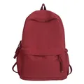 Minimalist burgundy campus backpack with front zipper pocket and fabric texture - Red