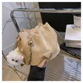 Beige bucket bag with adjustable gold ball chain strap and plush pendant accessory - With Plush Charm / Khaki