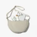 Beige nylon crescent crossbody bag showing spacious interior with phone and cosmetics - Off White