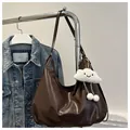 Brown leather tote bag with a white plush cloud charm hanging from the shoulder strap - With Pendant / Brown