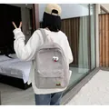 Grey corduroy backpack with cute cartoon eye design and embroidered patch detail - Light Gray