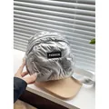 Quilted silver puffer crossbody bag for women with fashion label and fabric strap - Silver