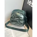 Quilted dark green puffer mini backpack with metallic finish and fashion label - Green