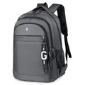 Mochila multifuncional de nailon gris oscuro con logo metálico y colgante decorativo - Gris