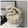 Creamy white plush bubble bag with braided handle and silver zipper closure - White